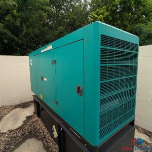 Angled rear view of Cummins C60D6C sound-attenuated generator enclosure outdoors